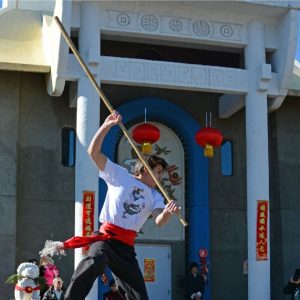 Matthew performing long staff at Chinese New Year